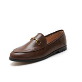 Women with horseshoe buckles and loafers wearing flat bottomed small leather shoes