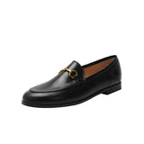 Women with horseshoe buckles and loafers wearing flat bottomed small leather shoes